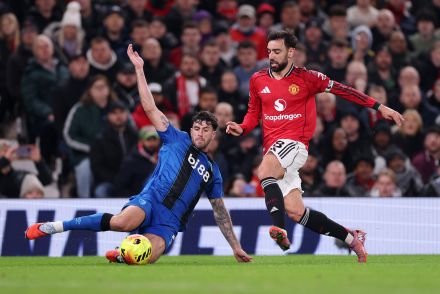 Marcos Senesi tackling Bruno Fernandes