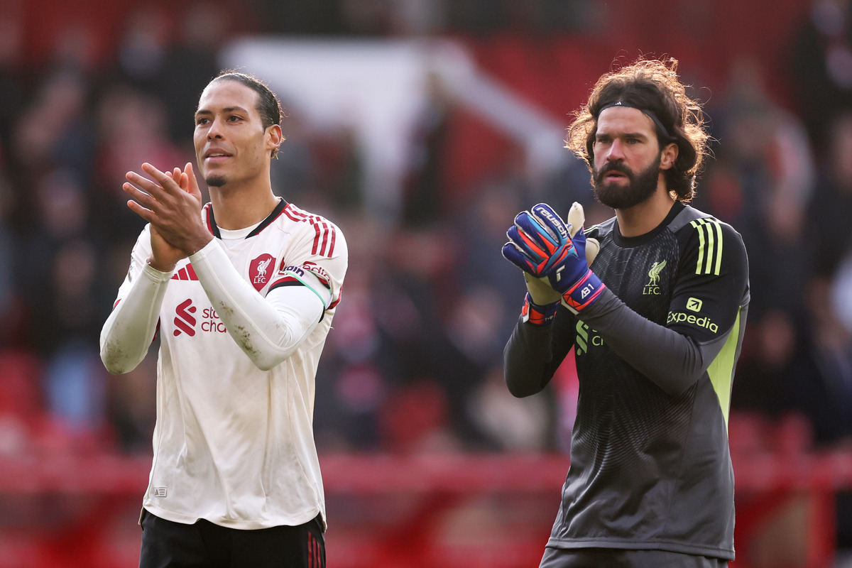 Alisson and Virgil van Dijk applauding Liverpool fans